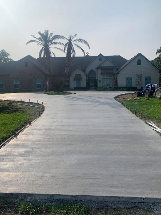 New concrete circle driveway in front of a brick home